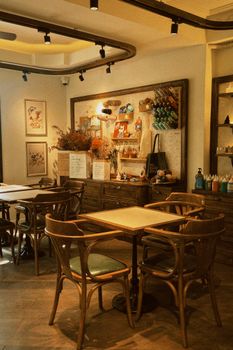 Warm vintage-style cafe interior featuring wooden furniture and cozy decor.