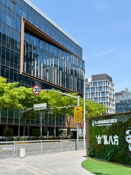 Modern office buildings in a vibrant Shanghai business district on a sunny day.