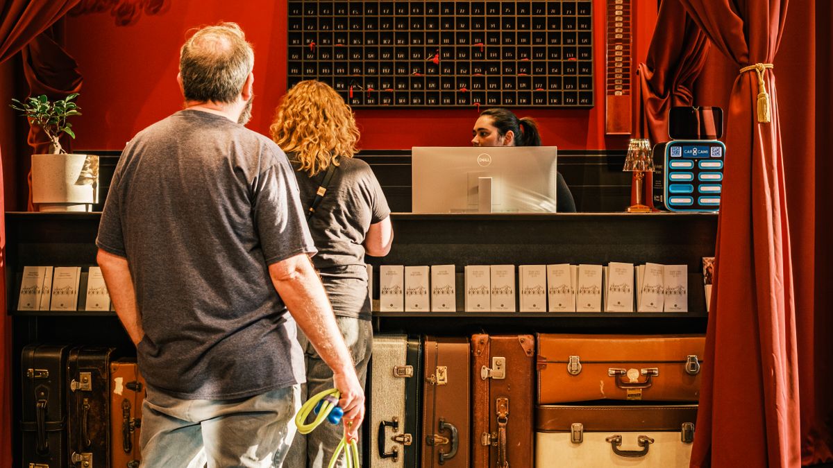 Travellers with dog checking in at a hotel; stock illustration, not an Ottawa hotel inspection