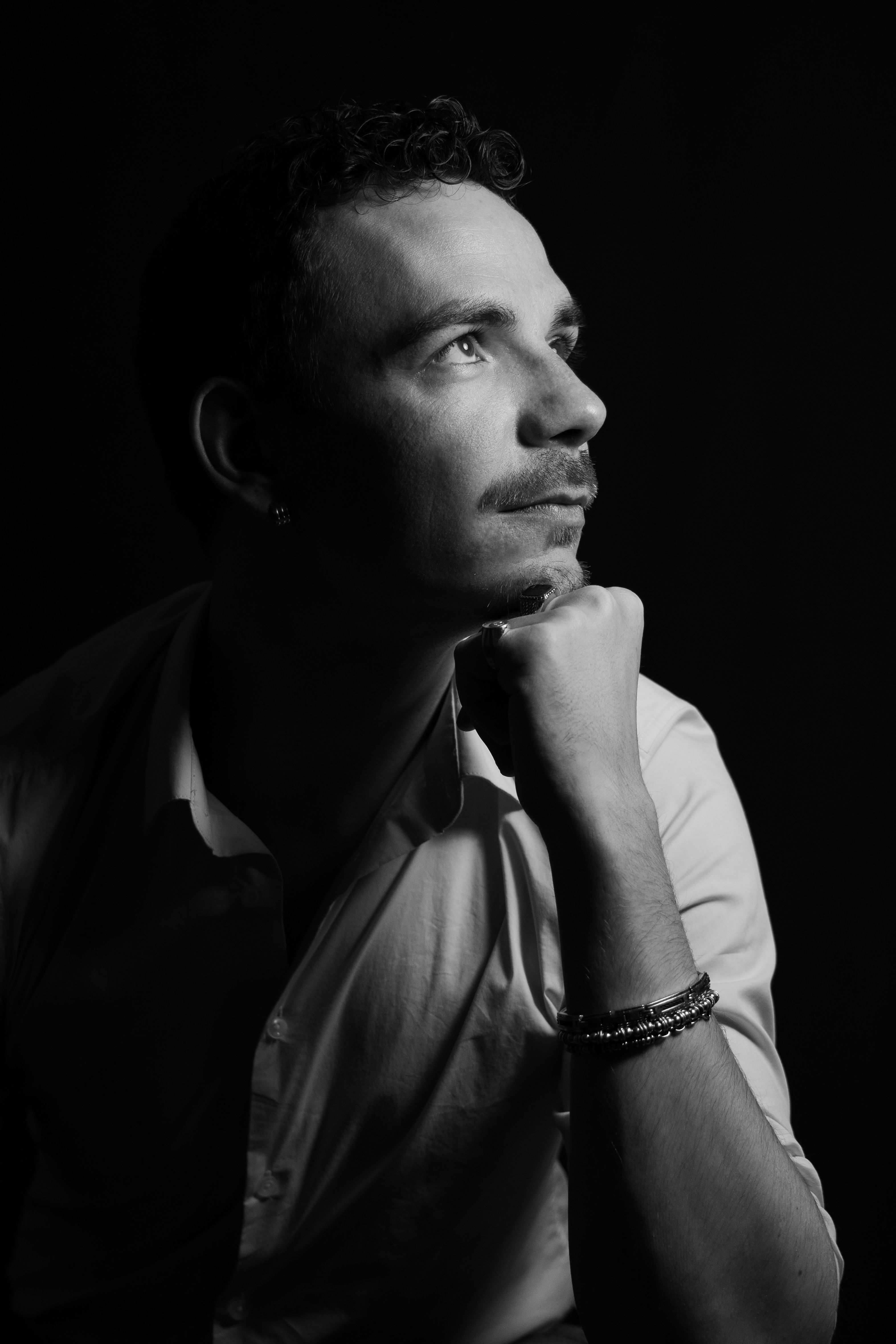 Dramatic Black and White Portrait of a Contemplative Man · Free Stock Photo