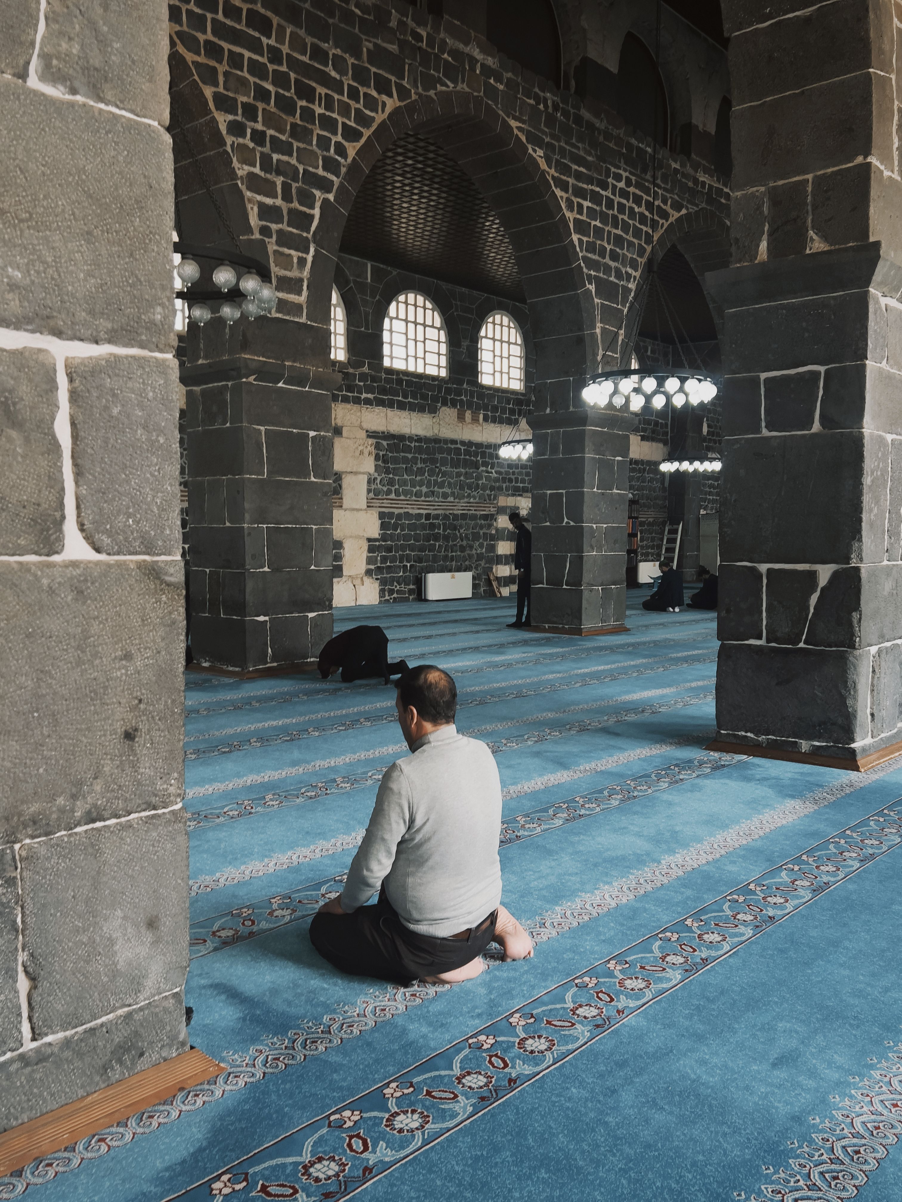 Blue carpet inside historic mosque prayer hall