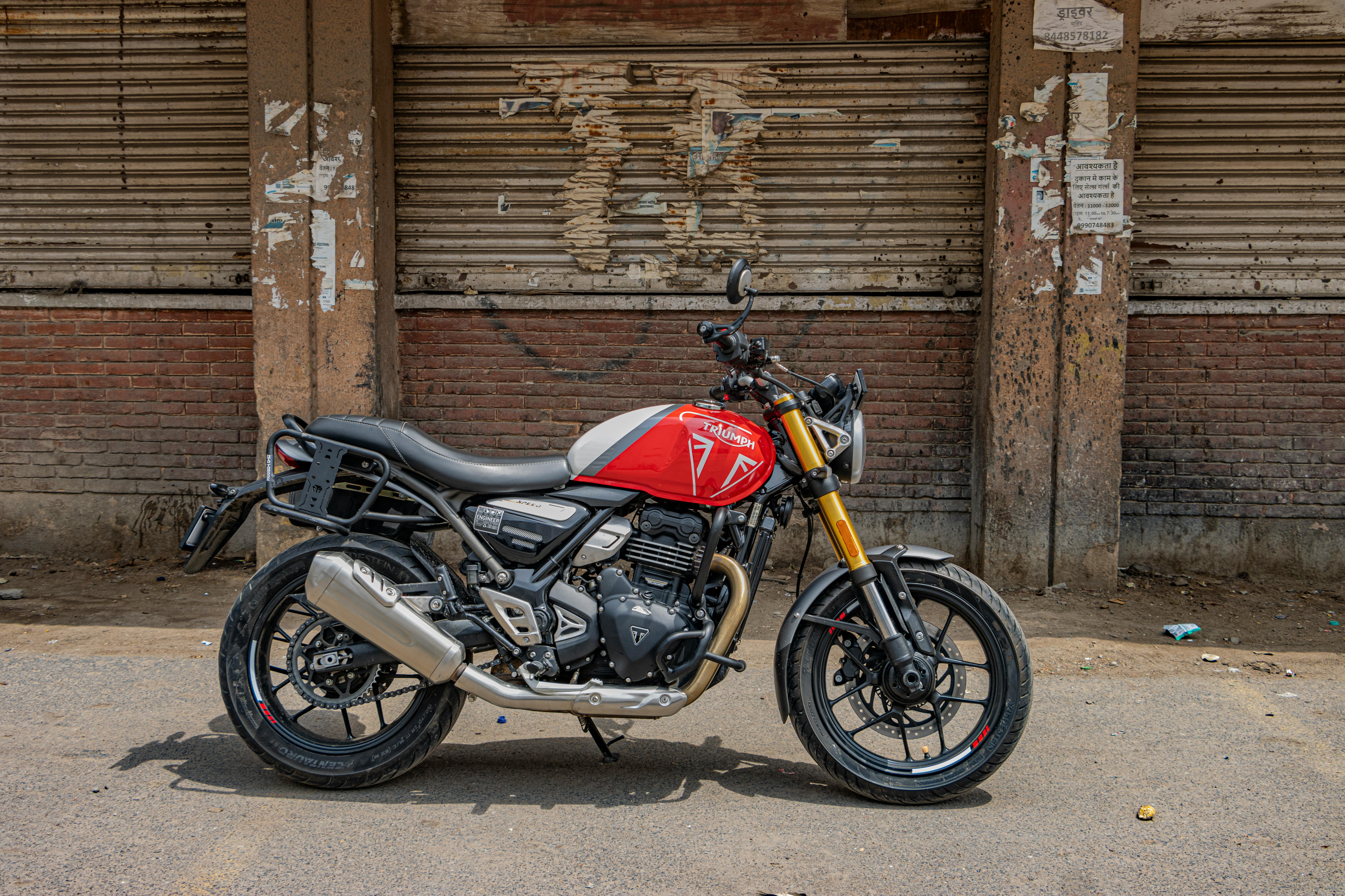 Triumph motorcycle parked outdoors in urban New Delhi, showcasing classic street culture.