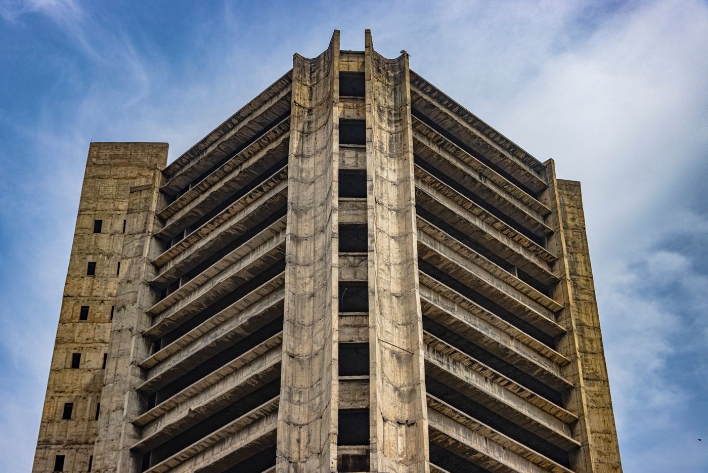 Concrete tower rising into a clear sky — photo by Shantum Singh on Pexels