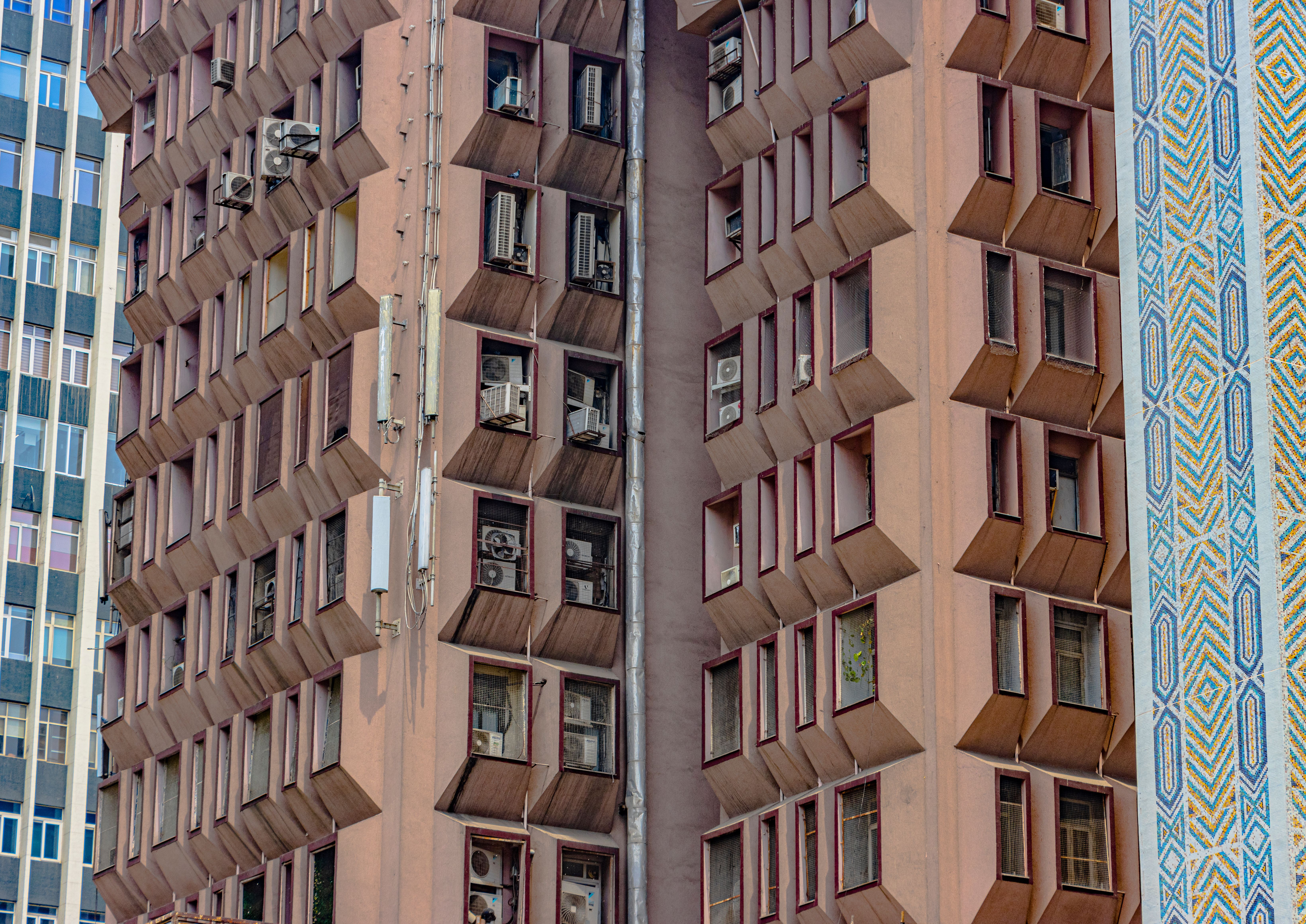 Symmetrical architecture with modern design and air conditioning units in New Delhi, India.