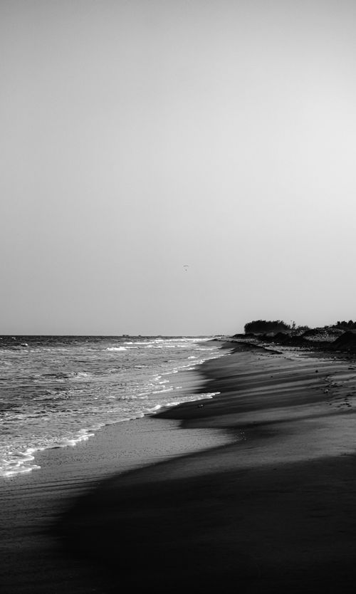 Free Quiet black and white beach scene in Puducherry capturing a serene coastline view. Stock Photo