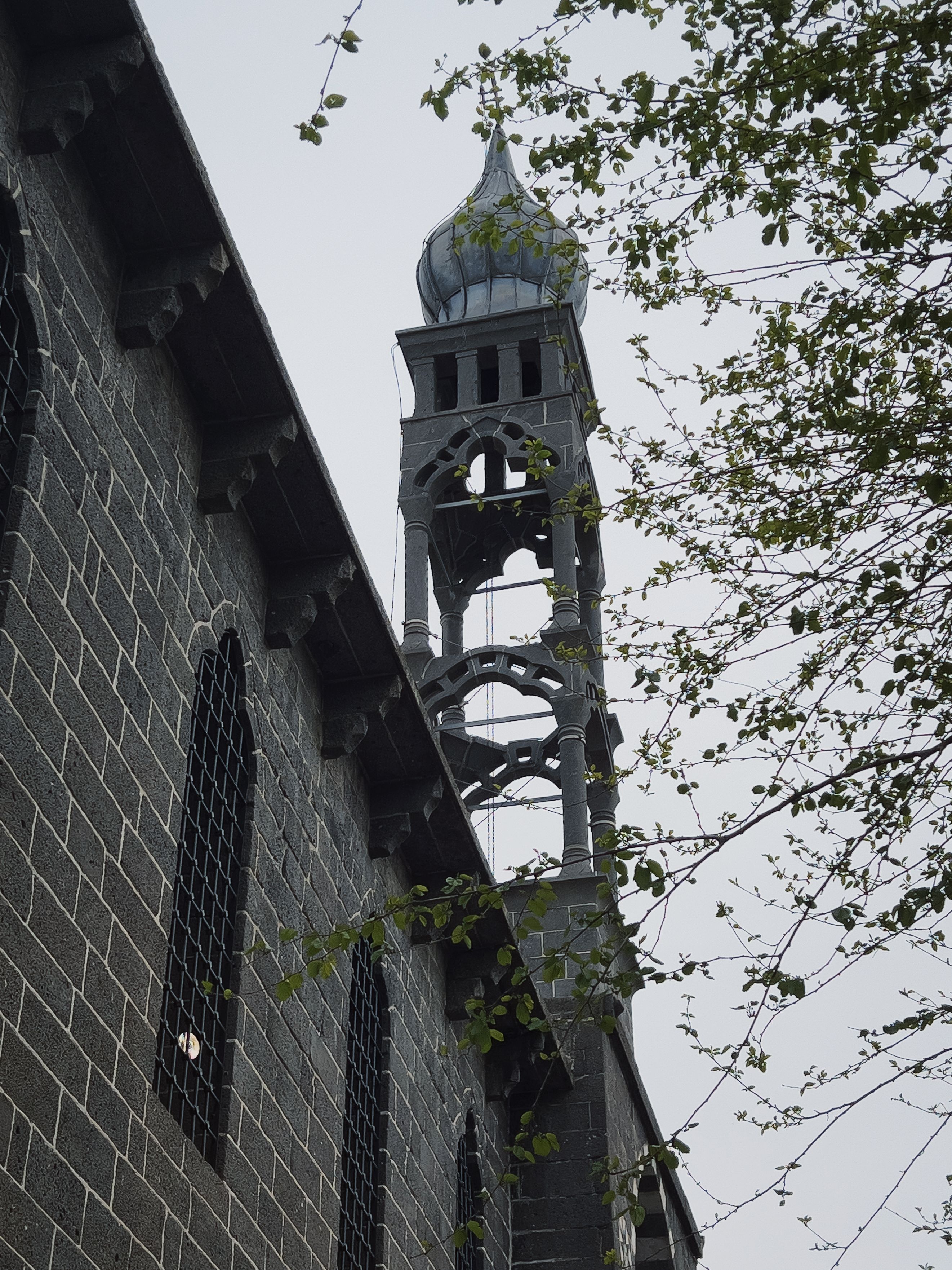 Gothic-style Bell Tower with Spring Foliage · Free Stock Photo