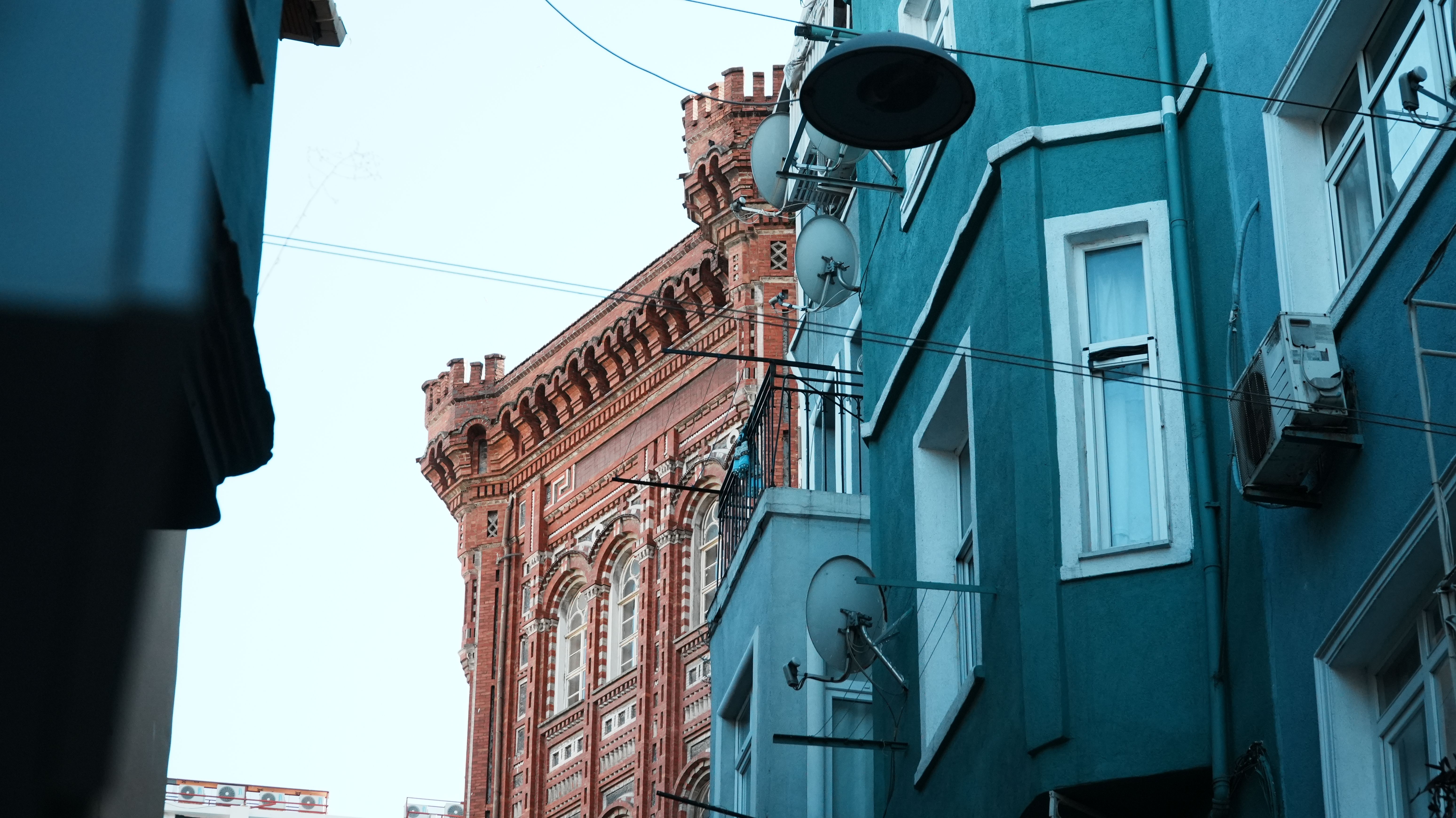 A striking blend of red brick Gothic architecture and modern urban buildings in İstanbul.