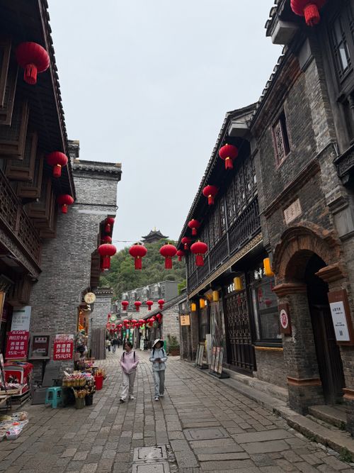 Free Charming ancient street with red lanterns and traditional Chinese architecture. Stock Photo