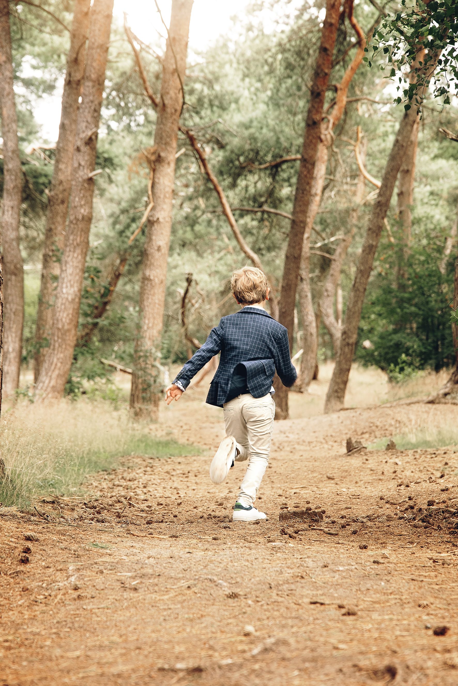 Child Running Freely in Sunlit Forest Trail · Free Stock Photo