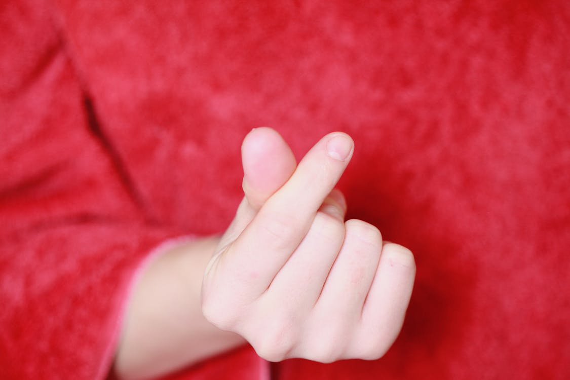 Free Persons Hand on Red Textile Stock Photo