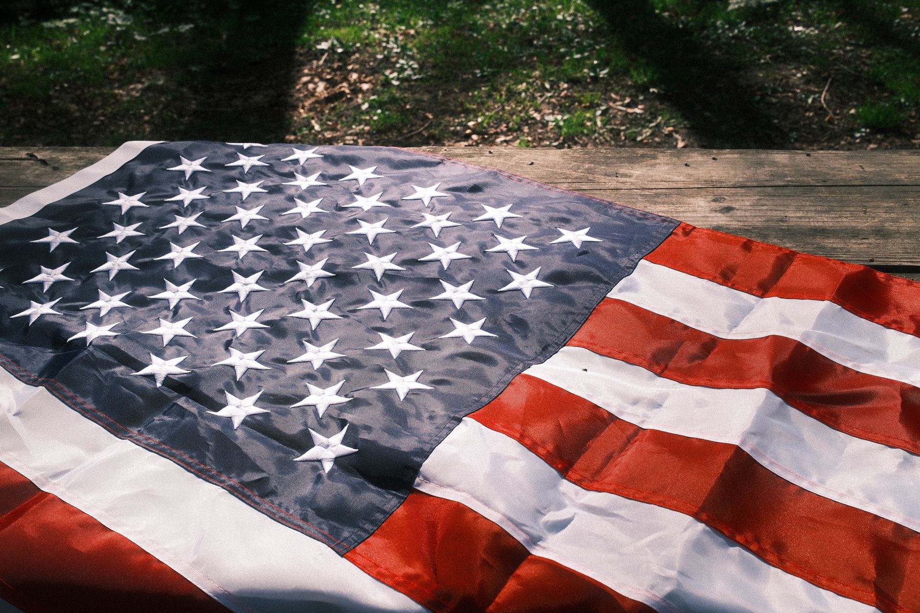 United States flag and a desk planner displaying July 3 and July 4, 2026 holiday observance dates