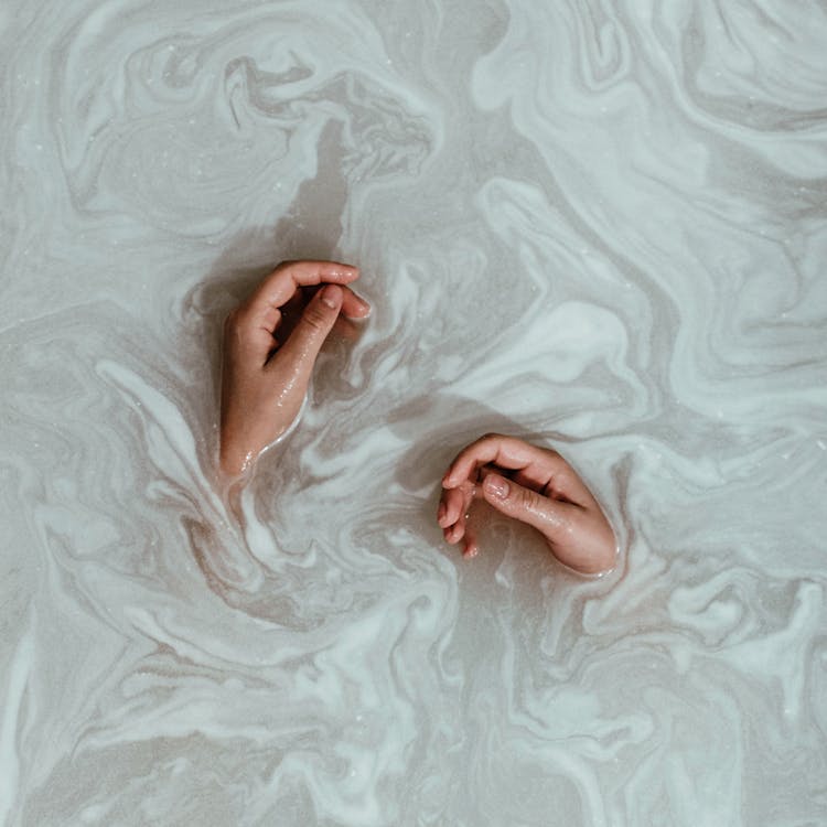 Person's Hands In The Water