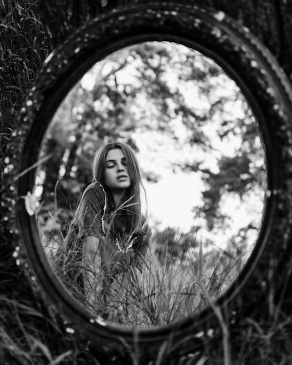 Grayscale Photo Of Woman's Reflection
