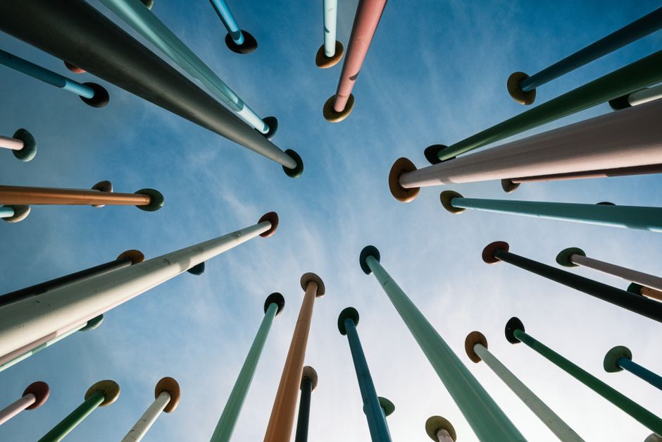 Artistic composition of vibrant vertical poles reaching towards the sky in Milan, Italy.