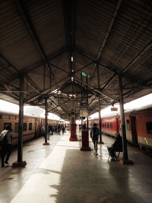 Free People walking at Lucknow train station, showcasing its symmetrical architecture and active atmosphere. Stock Photo
