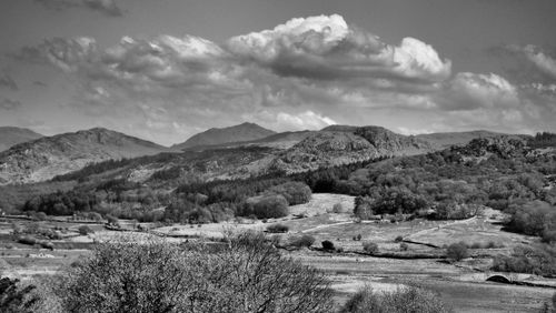 Free Black and white landscape of Ulverston's rolling hills under dramatic clouds. Stock Photo