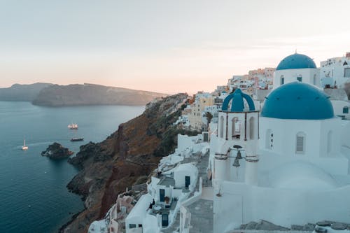 White And Blue Concrete Building Near Body Of Water