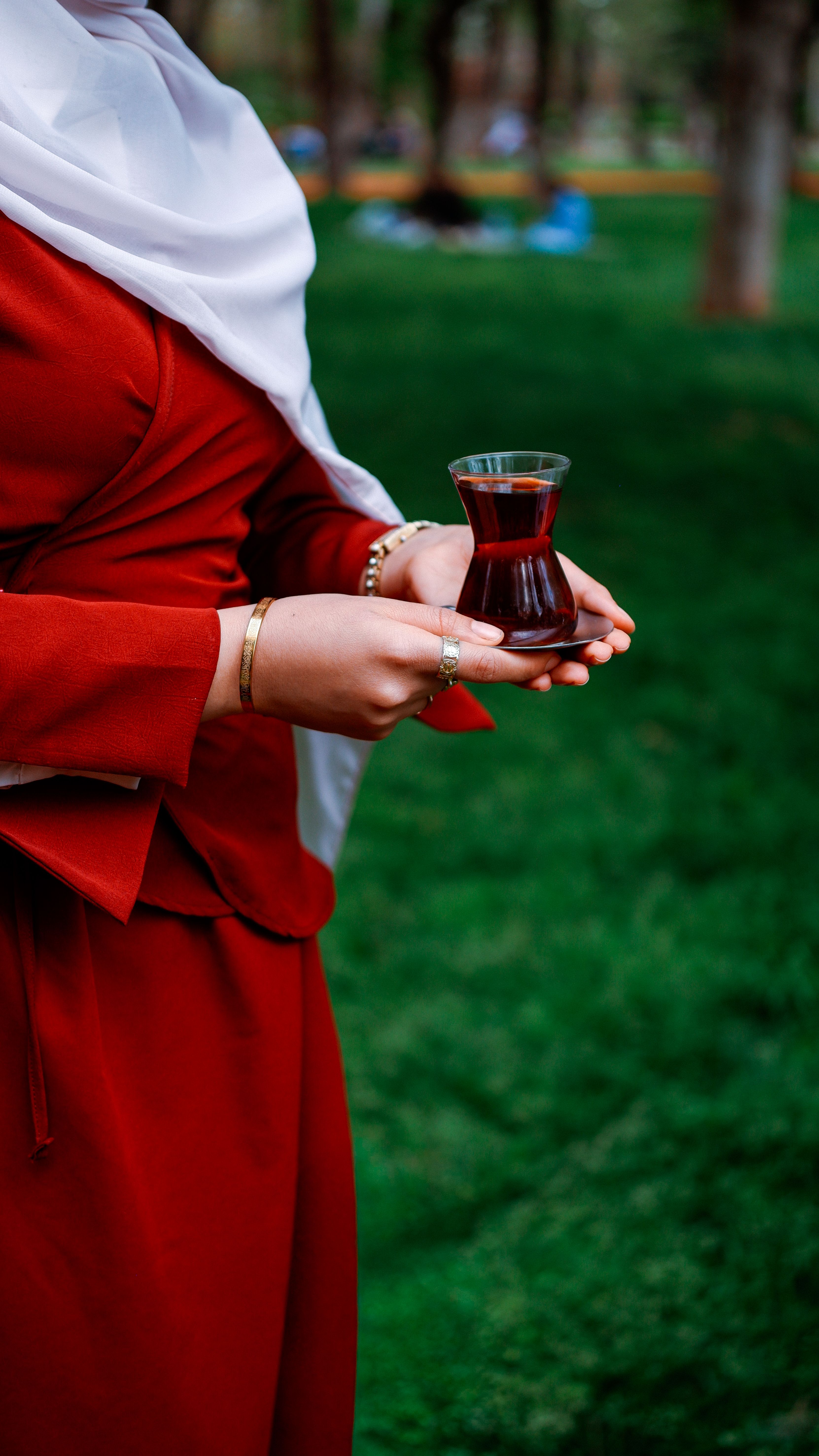 A person holding traditional Turkish tea in Gaziantep park, Türkiye. Perfect for cultural and travel themes.
