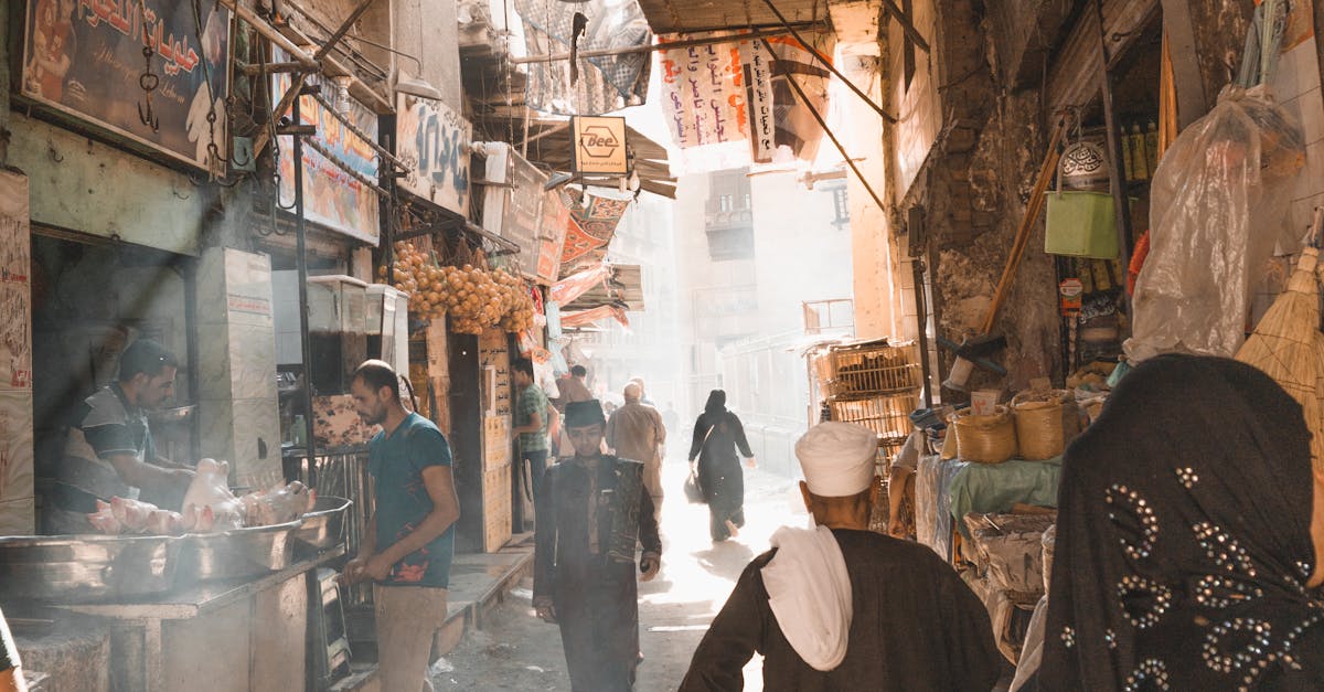 A vibrant street scene in Old Cairo, showcasing locals navigating a bustling market under colorful tarpaulins.