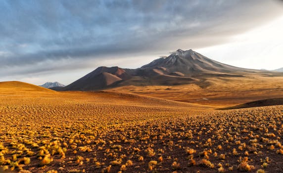 Stunning view of the Atacama Desert's mountains under a dramatic sky at dusk.