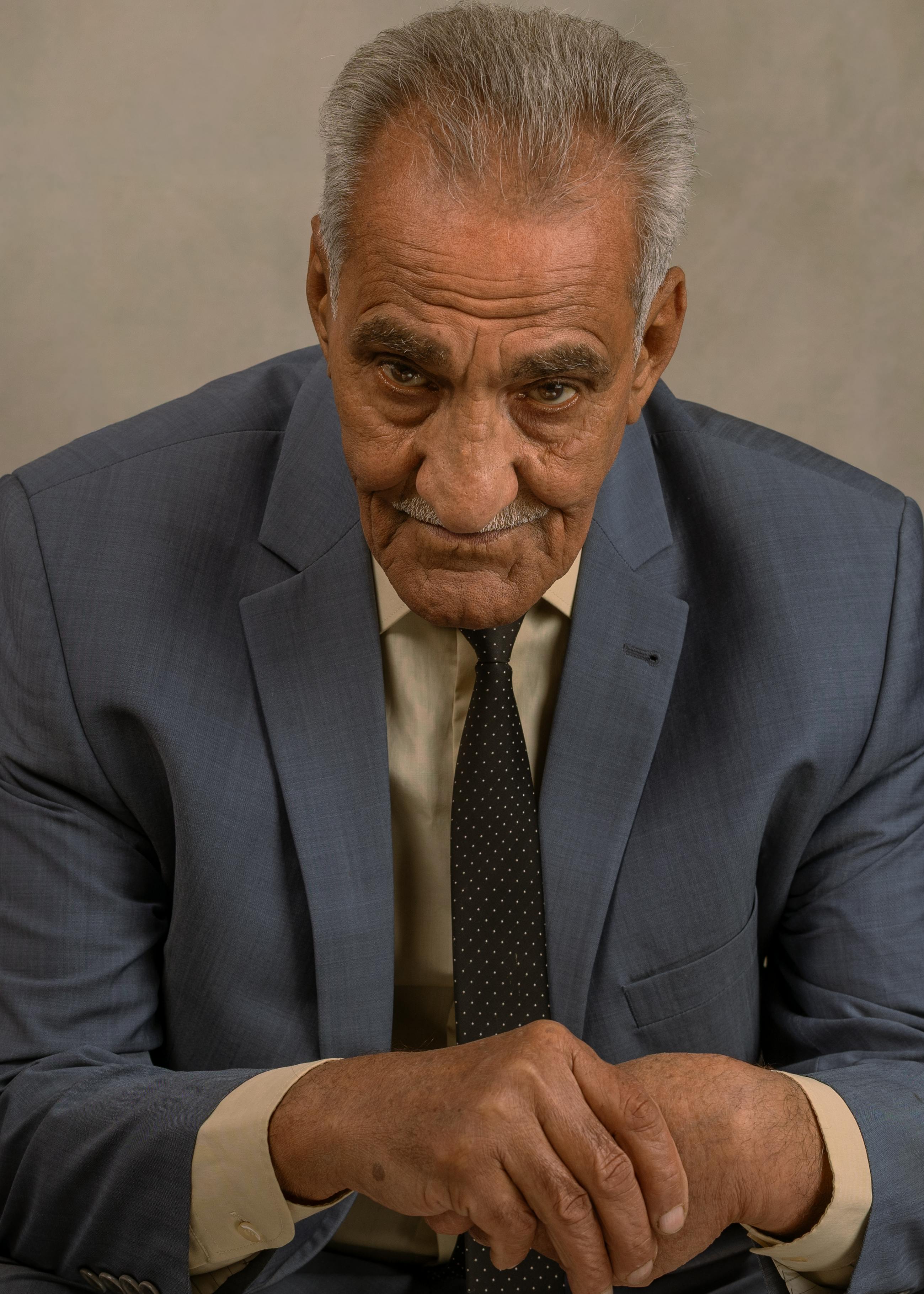Portrait of a senior man in a suit, exuding wisdom and experience.