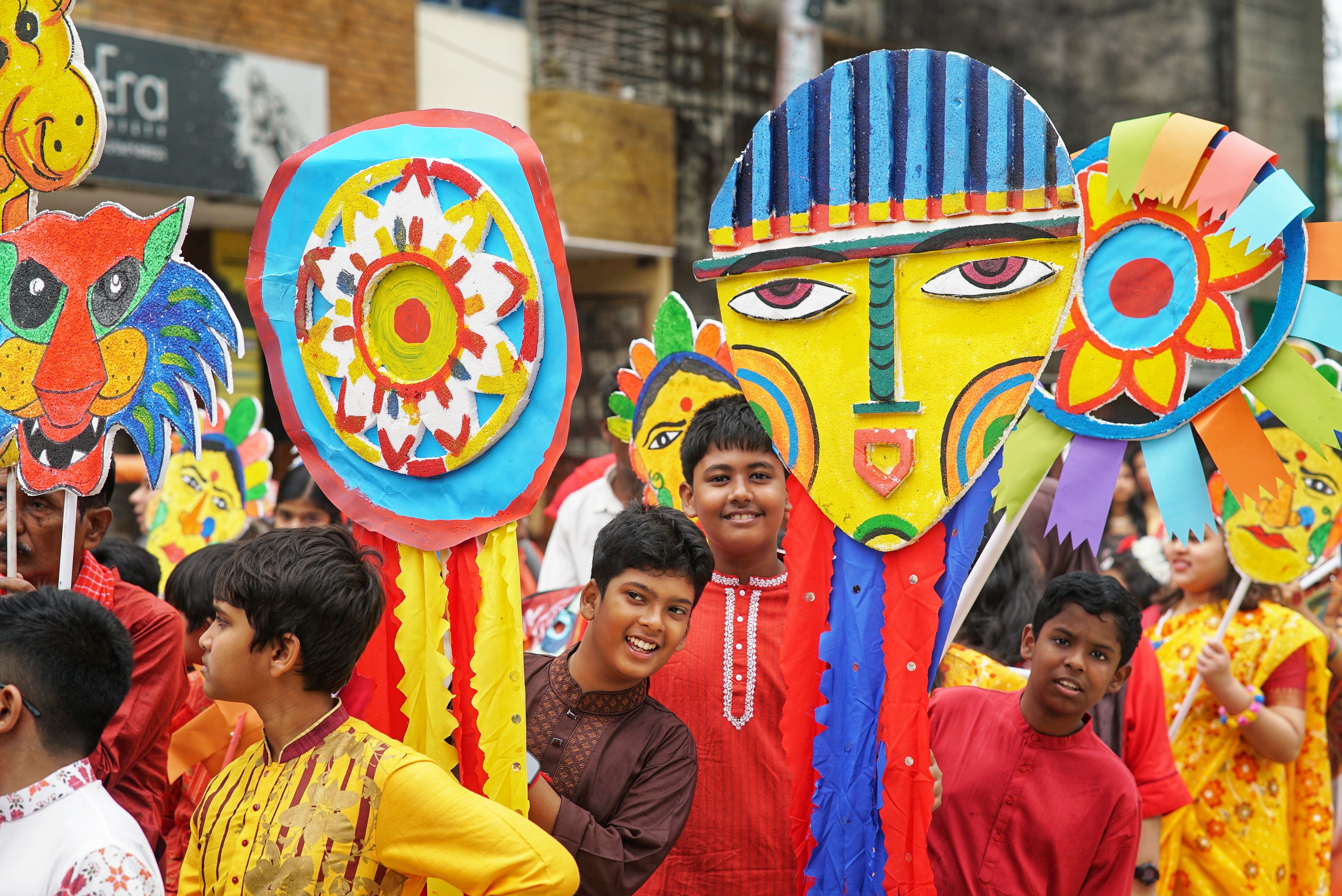 Vibrant festival parade showcasing children with colorful masks and costumes, celebrating tradition.