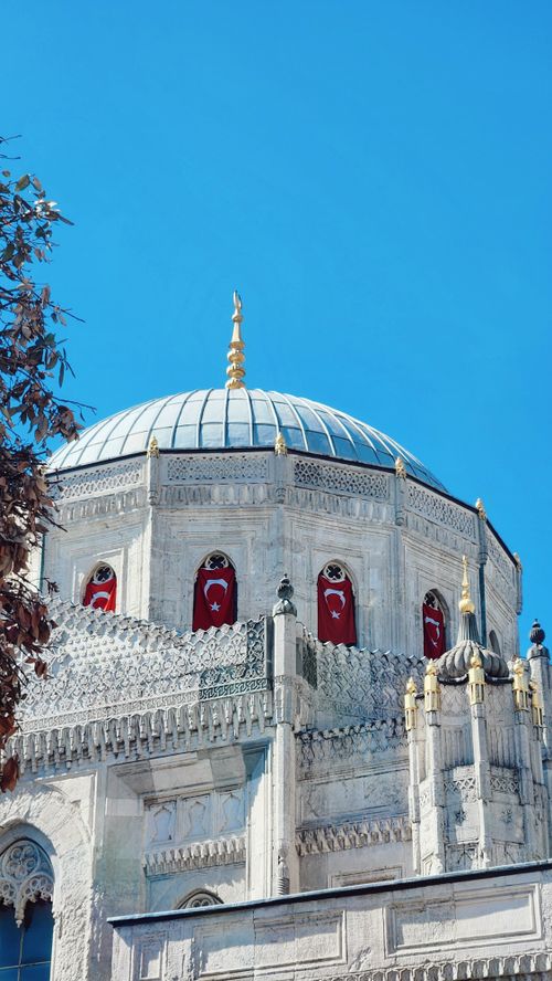 Free Stunning view of a historic Ottoman dome with vibrant Turkish flags and ornate architecture. Stock Photo