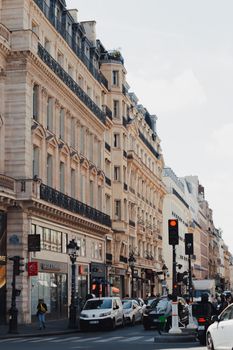 A bustling street in Paris showcasing historic architecture and urban life.