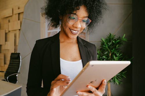 Free Woman In Black Blazer Holding An Ipad Stock Photo