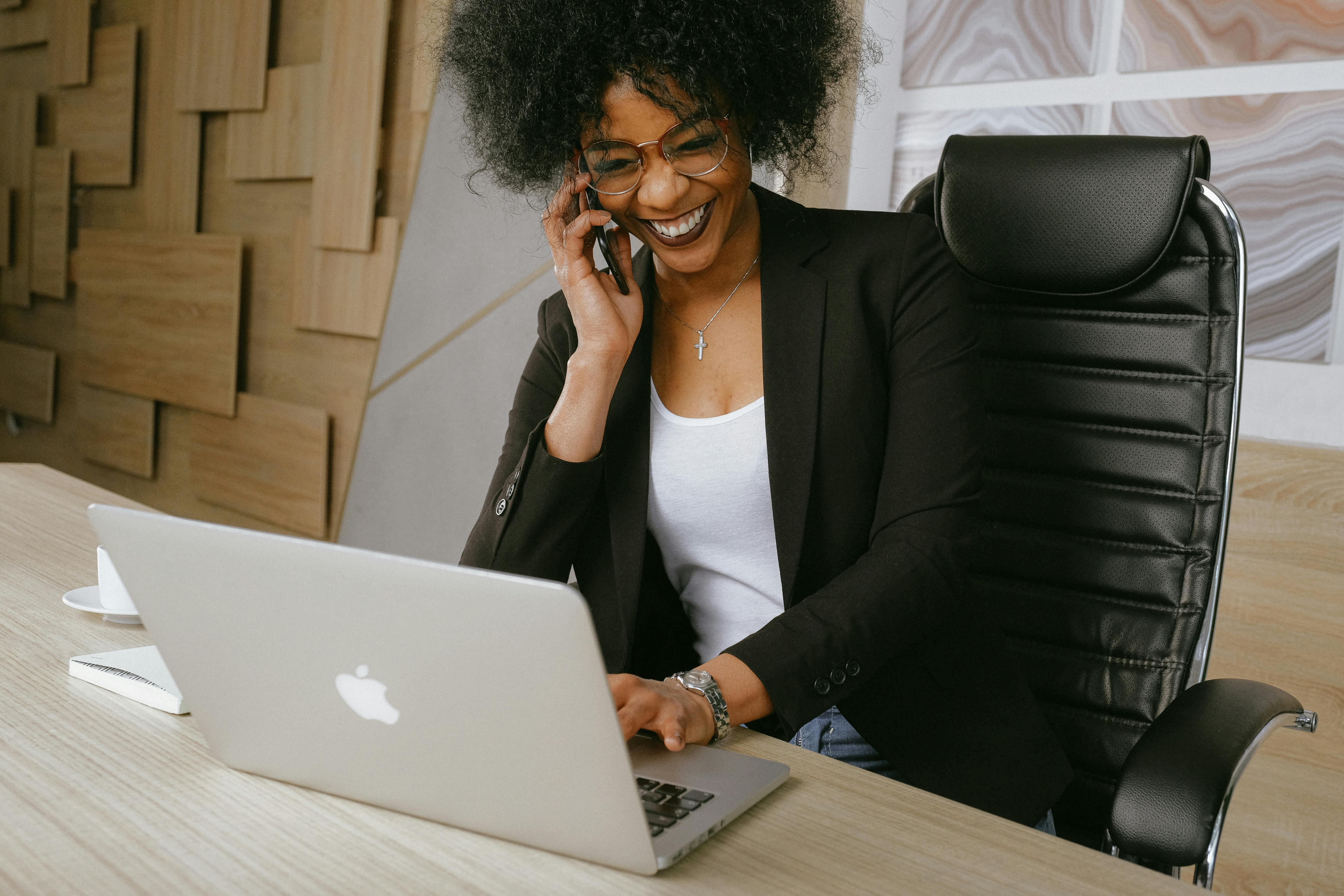 Woman in a black blazer sitting on a black office chair