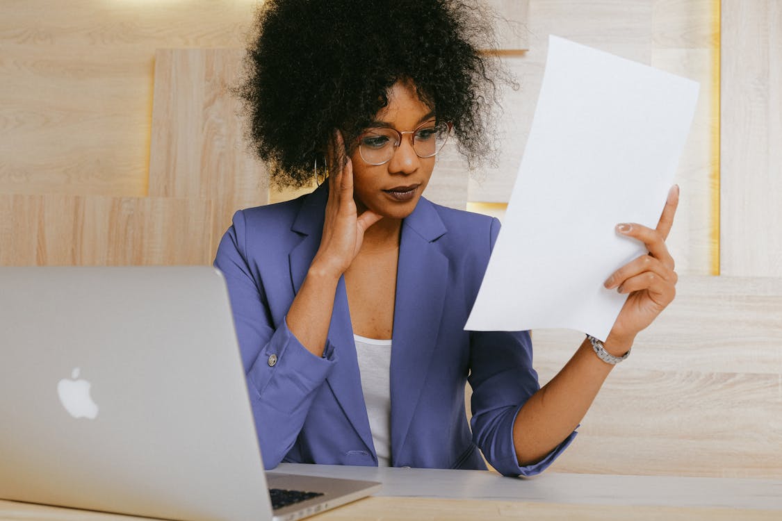 Woman In Blue Blazer Holding White Paper