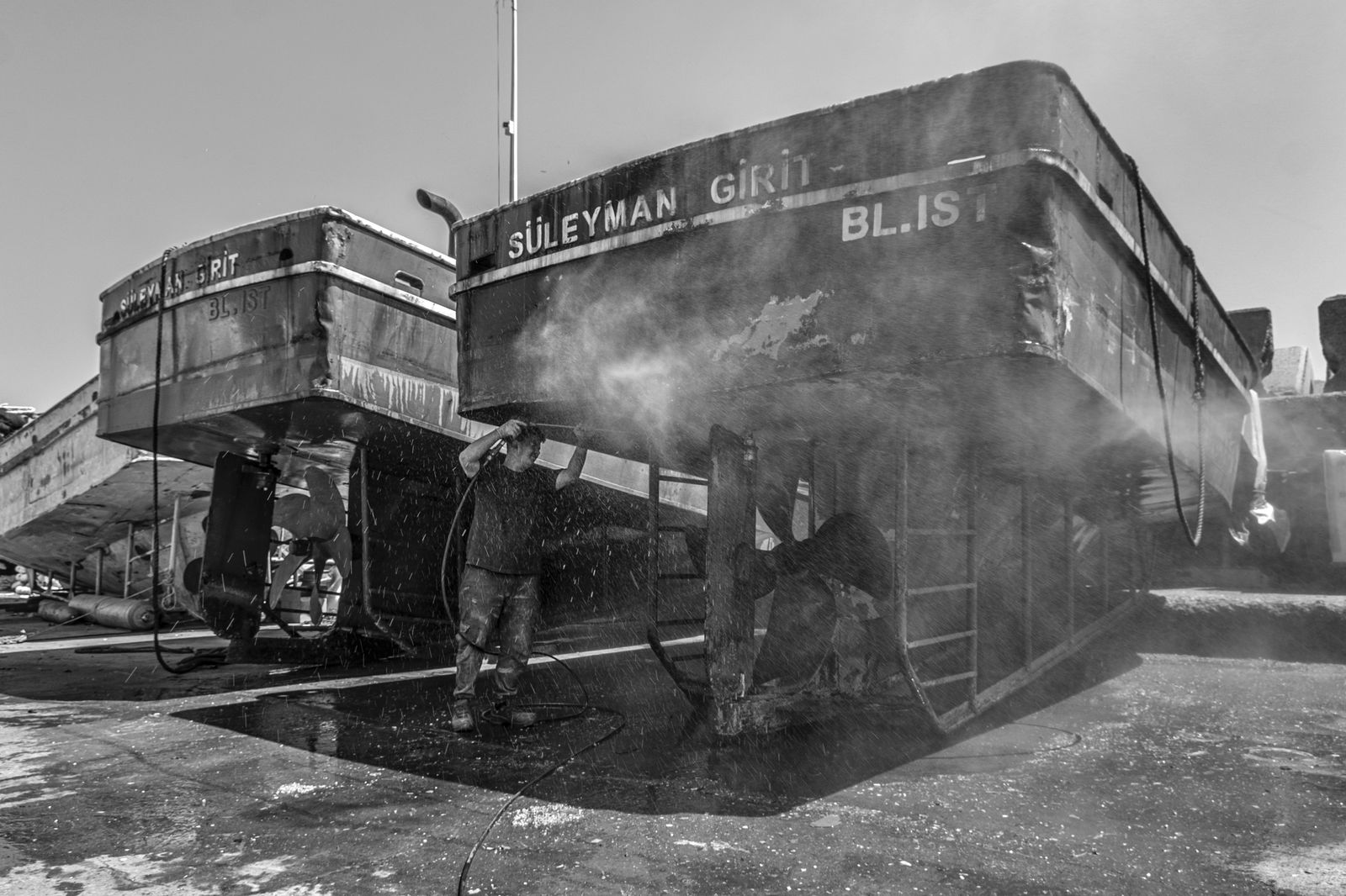 Marine cleaning work on a boat at a dock