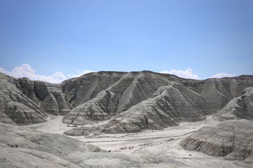 Free Dramatic view of rugged desert badlands under clear blue sky. Perfect for nature and travel themes. Stock Photo