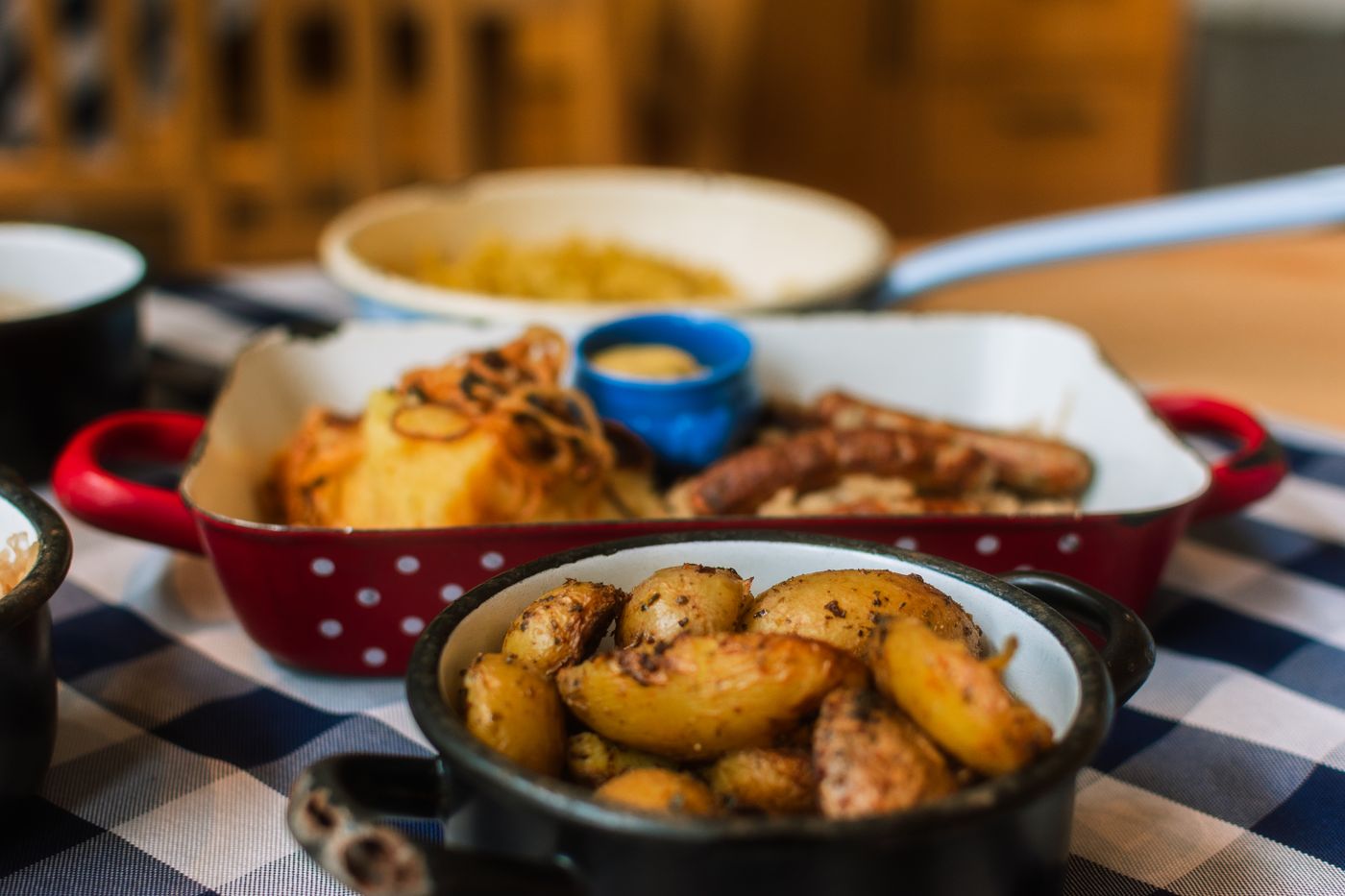 Close-up of savory roasted potatoes and sausages, perfect for rustic meal themes.