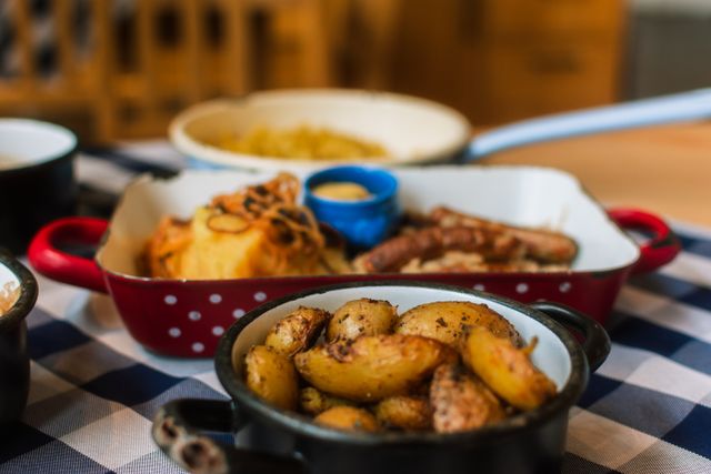 Close-up of savory roasted potatoes and sausages, perfect for rustic meal themes.