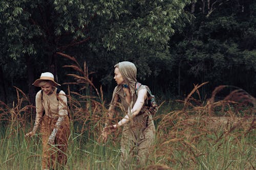 Women Standing in Grass Field