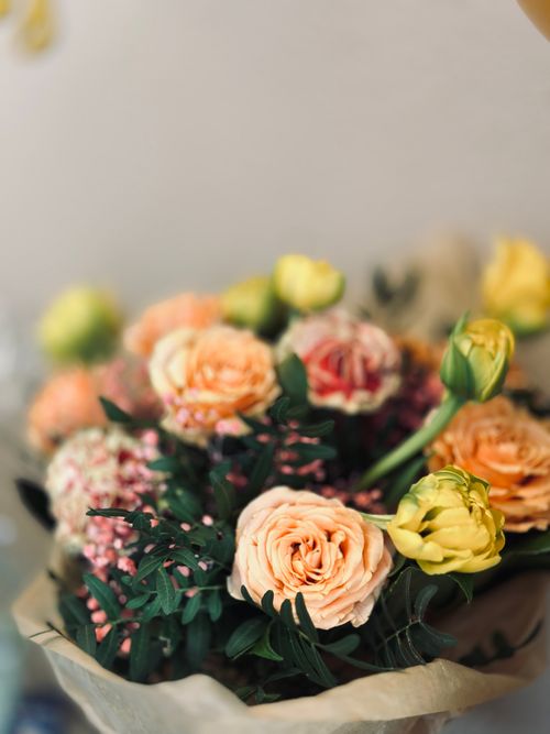 Free A vivid spring bouquet of mixed flowers in warm tones, ideal for floral decor. Stock Photo