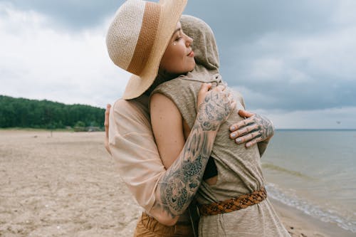 Women Hugging on Beach