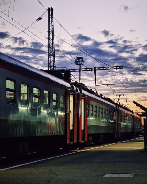 Free City train station with trains at sunset, vibrant sky and urban setting. Stock Photo