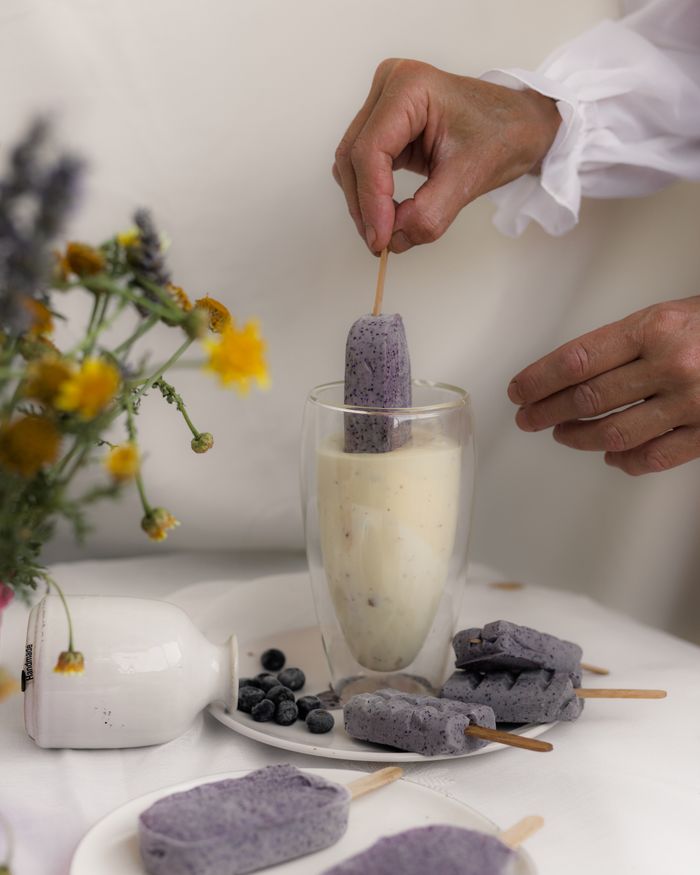 A chic setup of homemade blueberry ice pops with an artistic touch