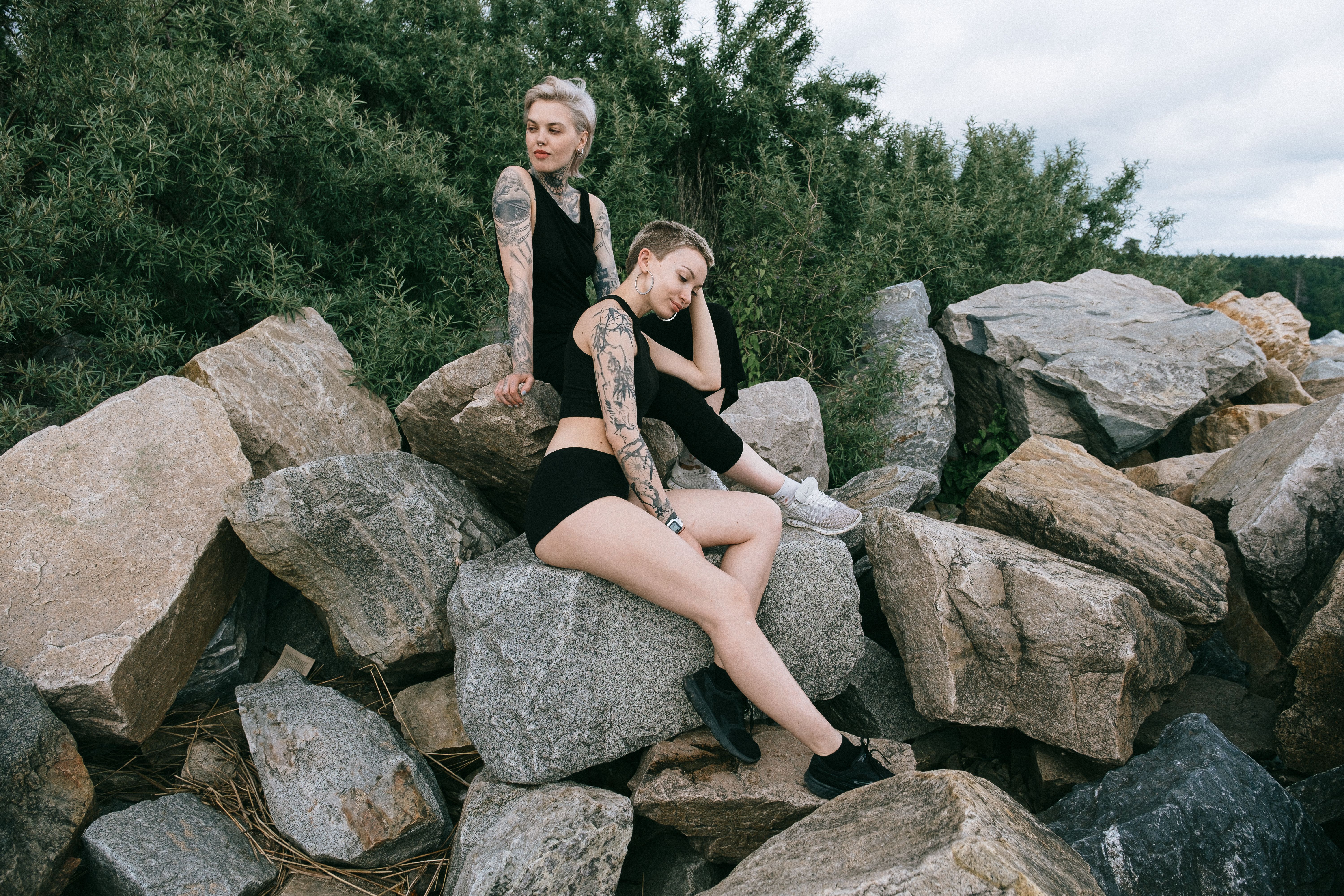 Women Sitting on Rocks · Free Stock Photo