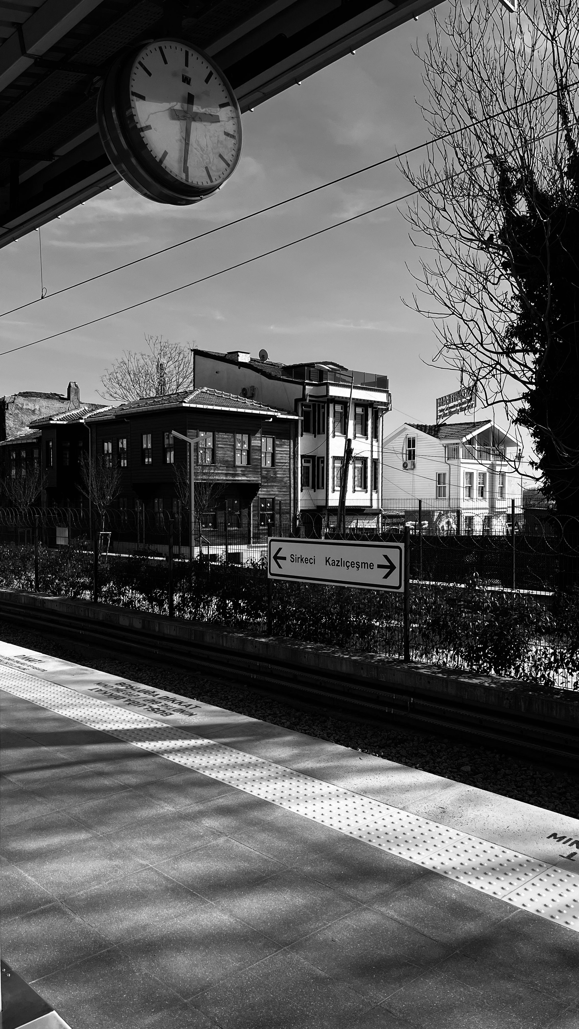 Historic train station platform captured in black and white, evoking nostalgic charm.