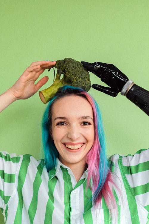 Woman In Green And White Stripe Shirt Holding A Broccoli