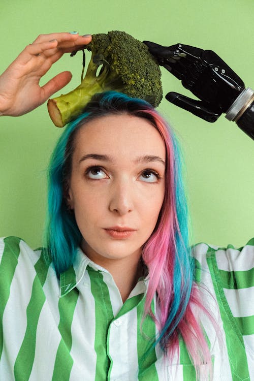Woman In Green And White Stripe Shirt Holding A Broccoli