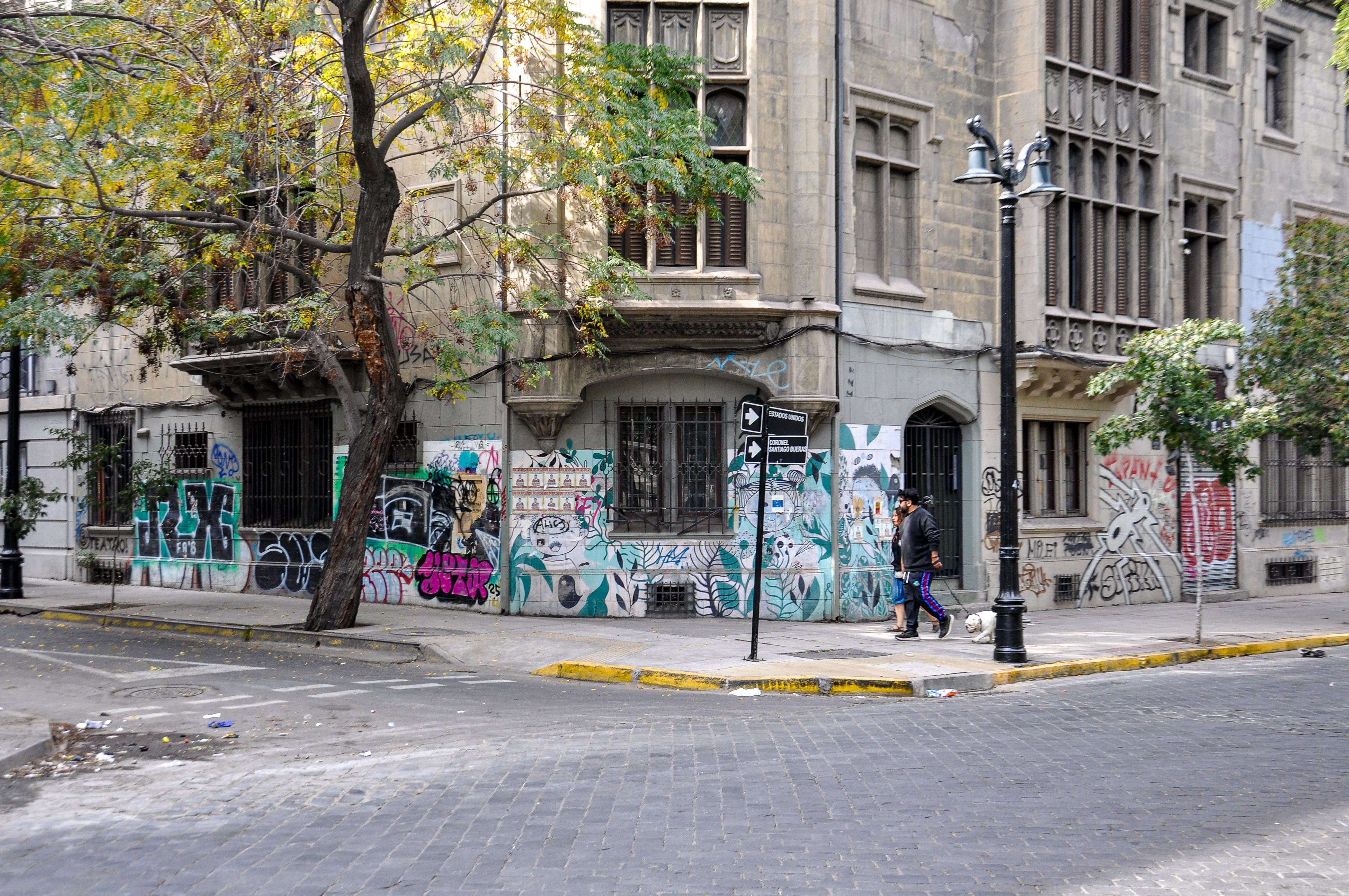 Urban street view in Santiago, Chile featuring graffiti and classic architecture.