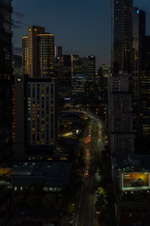 Free Stunning night view of Melbourne cityscape showcasing illuminated skyscrapers and bustling streets. Stock Photo