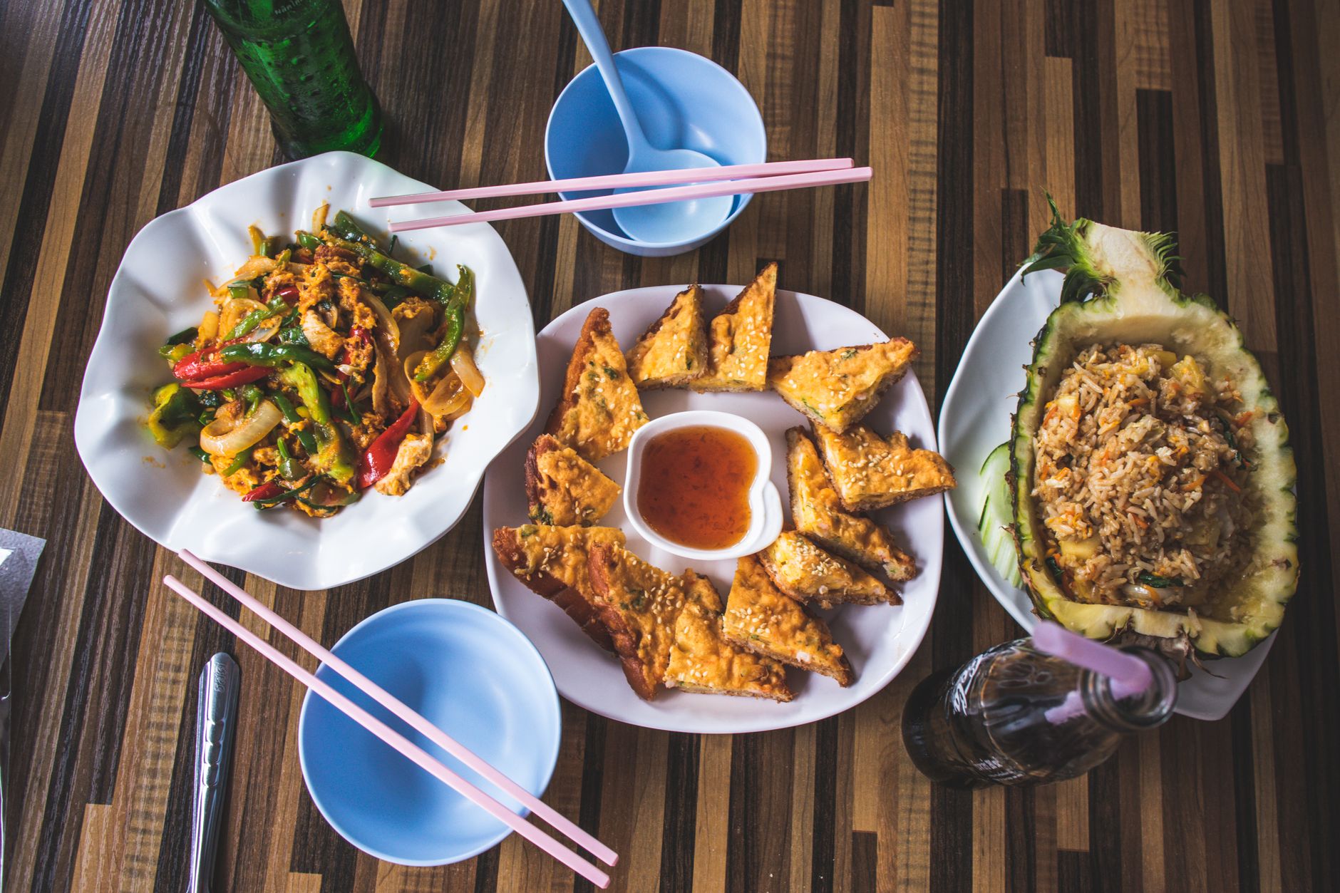 Delicious Asian dishes including stir fry, crispy wontons, and pineapple fried rice presented elegantly.