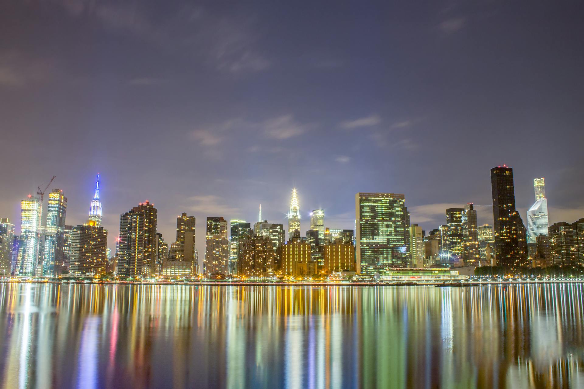 City Skyline Across Body of Water during Night Time