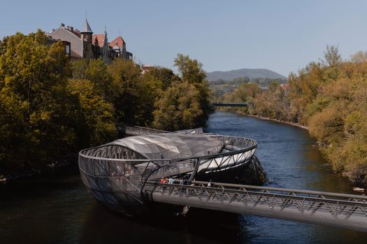 Discover the stunning Murinsel bridge in Graz, Austria, blending art and nature in a unique structure.