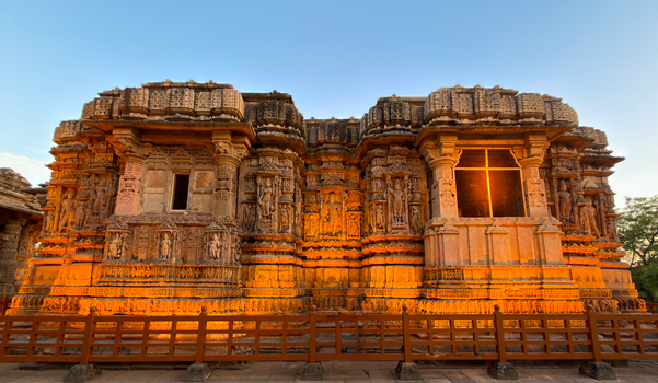 Explore the captivating architectural details of the Sun Temple in Modhera, Gujarat, India during a warm sunset.